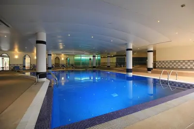 a large indoor swimming pool with a large blue pool at Suite Hotel Jardins Da Ajuda in Funchal
