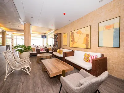 a lobby with couches and chairs and a table at Vila Baleira Suites in Porto Santo