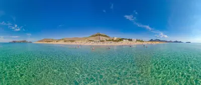 a group of people on a beach in the water at Vila Baleira Suites in Porto Santo