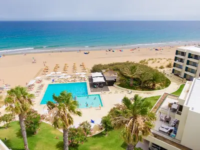 a view of the beach from the balcony of a resort at Vila Baleira Suites in Porto Santo