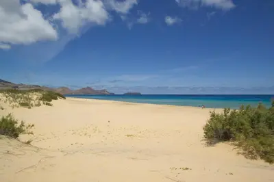 a sandy beach with the ocean in the background at Hotel Praia Dourada in Porto Santo