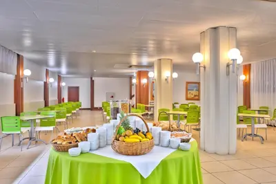 a table with baskets of fruit on it in a cafeteria at Hotel Praia Dourada in Porto Santo