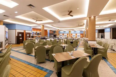 a dining room with tables and chairs at Pestana Porto Santo Premium All Inclusive Beach & SPA Resort in Porto Santo