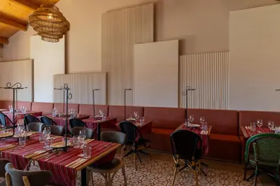 a dining room with red tables and chairs at Pestana Porto Santo Premium All Inclusive Beach & SPA Resort in Porto Santo
