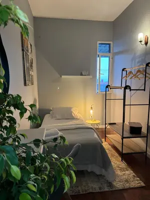 a bedroom with a bed and a plant at Residencial Funchal in Funchal