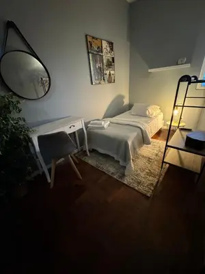 a bedroom with a bed and a desk and a lamp at Residencial Funchal in Funchal
