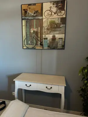 a desk in a room with a picture on the wall at Residencial Funchal in Funchal