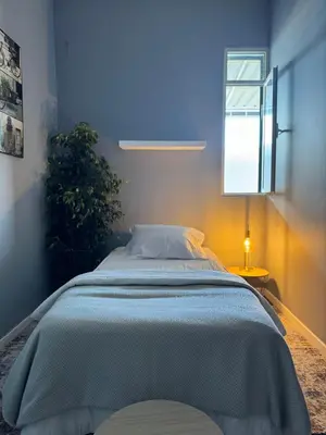 a bed in a bedroom with a blue wall at Residencial Funchal in Funchal