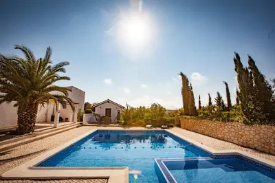 a swimming pool in a yard with trees and a building at Casa do Pocinho in Raposeira