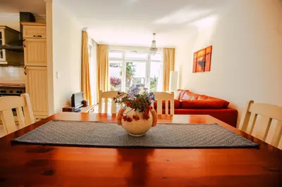 a living room with a table with a vase on it at Casa do Pocinho in Raposeira