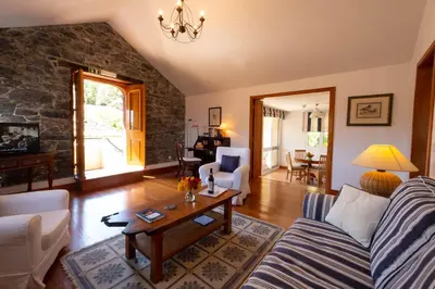 a living room with a couch and a table at OurMadeira - Casa do Feitor in Funchal