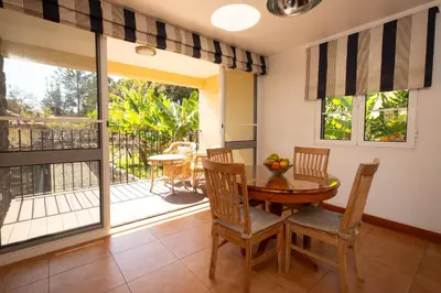 a dining room with a table and chairs and a balcony at OurMadeira - Casa do Feitor in Funchal