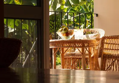 a table and chairs with a bowl of fruit on it at OurMadeira - Casa do Feitor in Funchal