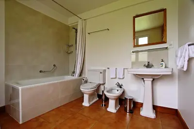 a bathroom with a sink and a toilet and a bath tub at OurMadeira - Casa do Feitor in Funchal