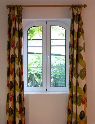 two windows in a room with curtains at OurMadeira - Casa das Vinhas in Funchal