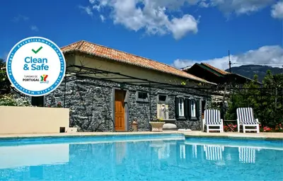a villa with a swimming pool in front of a house at OurMadeira - Casa das Vinhas in Funchal