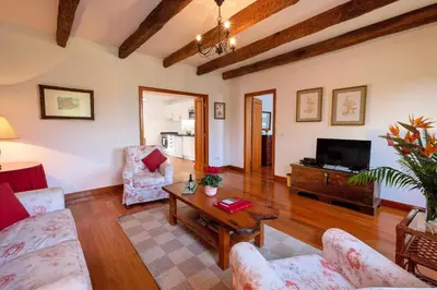 a living room with a couch and a table at OurMadeira - Loja da Lenha in Funchal