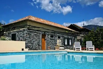 a house with a swimming pool and two chairs at OurMadeira - Loja da Lenha in Funchal