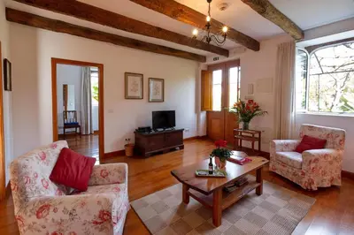 a living room with two chairs and a coffee table at OurMadeira - Loja da Lenha in Funchal