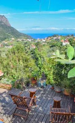 a wooden deck with a view of the ocean at La Maison ZiaZen in Porto da Cruz