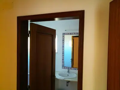 a bathroom with a sink and a mirror at Porto Mos Residence in Lagos