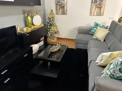 a living room with a couch and a table at Zeza´s apartament in Calheta