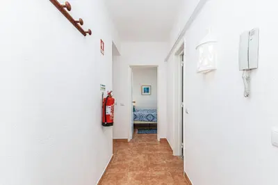 a hallway with a fire extinguisher in a room at Casa do Coral - Praia da Luz in Luz