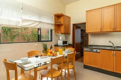 a kitchen with a table and chairs in a kitchen at Casa Fatima in Funchal