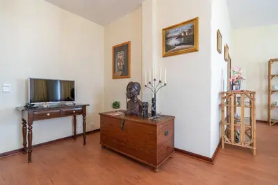 a living room with a tv and a dresser at Casa Fatima in Funchal