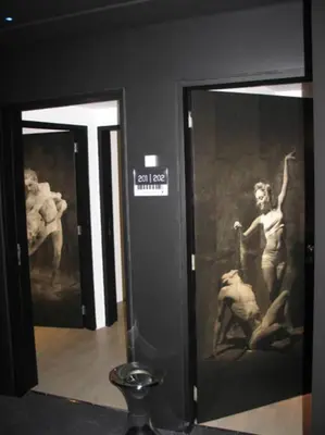 a room with two glass doors with paintings on the walls at Funchal Design Hotel in Funchal