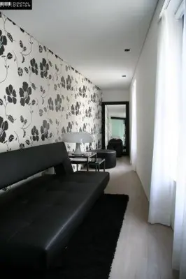a living room with a couch and a wall at Funchal Design Hotel in Funchal