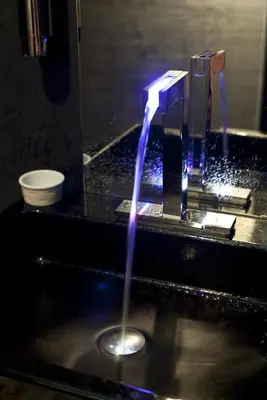 a stream of water coming out of a sink at Funchal Design Hotel in Funchal