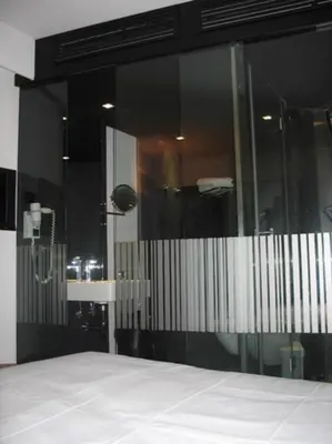 a bathroom with a shower and a glass wall at Funchal Design Hotel in Funchal