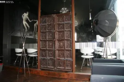 a room with a table and some chairs and a mirror at Funchal Design Hotel in Funchal