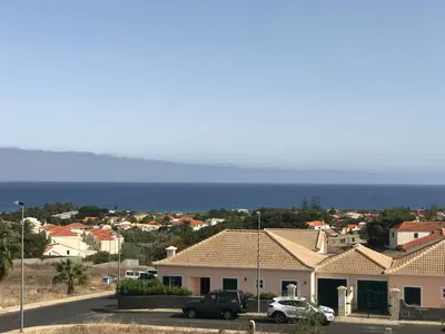 a view of a town with houses and the ocean at Duplex Ocean View in Porto Santo