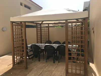 a gazebo with a table and chairs under it at Duplex Ocean View in Porto Santo