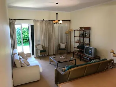 a living room with a couch and a tv at Duplex Ocean View in Porto Santo
