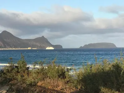 a view of the ocean with mountains in the background at Duplex Ocean View in Porto Santo