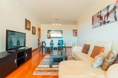 a living room with a couch and a tv at FLH Funchal Green Park Apartment with Pool in Funchal