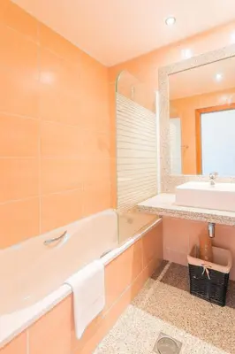 a bathroom with a tub and a sink at FLH Funchal Green Park Apartment with Pool in Funchal