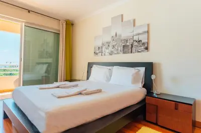 a bedroom with a bed with two towels on it at FLH Funchal Green Park Apartment with Pool in Funchal