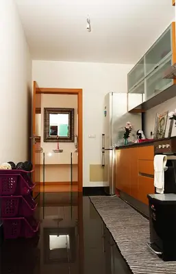 a kitchen with a sink and a mirror on the wall at Sunny Little Sister Apartment - 7 min walking from the beach and at 7 min driving from the Airport in Machico