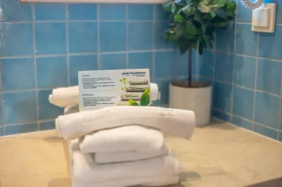 a pile of towels sitting on a counter in a bathroom at Pontalaia Apartamentos Turísticos in Sagres
