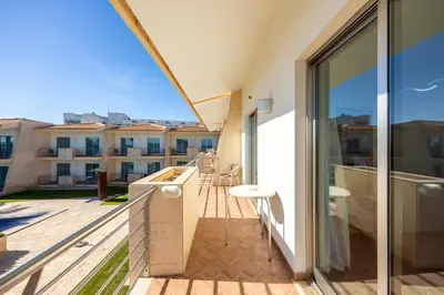 a balcony with a view of a building at Pontalaia Apartamentos Turísticos in Sagres