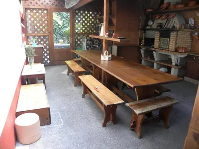 a large wooden table and benches in a room at Moradia Ponte de Pedra in São Vicente