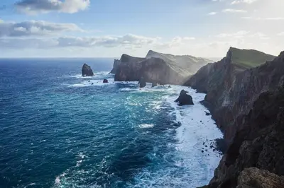 an aerial view of the ocean with a rocky coastline at Reid's Palace, A Belmond Hotel, Madeira in Funchal