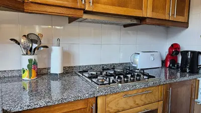 a kitchen with a stove and a counter top at Refúgio da Ribeira in Porto Moniz