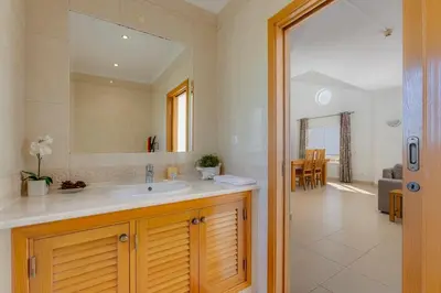 a bathroom with a sink and a mirror at The View – Santo António Villas, Golf & Spa in Salema