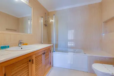 a bathroom with a tub and a sink and a toilet at The View – Santo António Villas, Golf & Spa in Salema