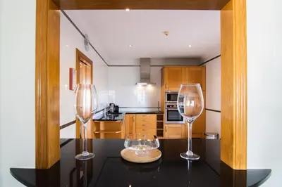 two wine glasses sitting on a table in a kitchen at The View – Santo António Villas, Golf & Spa in Salema